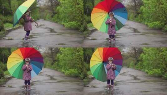 拿着彩虹伞的女孩在公园跳跃高清在线视频素材下载
