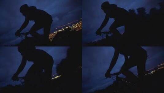 男子夜晚骑自行车背影高清在线视频素材下载