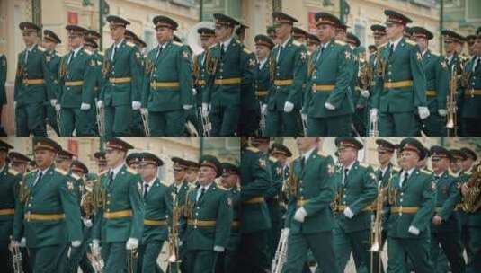 俄罗斯，喀山09-08-2019：管乐器游行-身着绿色服装的军事音乐家手持乐器在街上行进高清在线视频素材下载