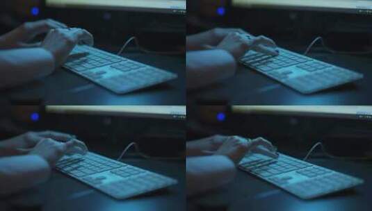 背光黑暗办公室中女性手在键盘上打字的低角度照片高清在线视频素材下载