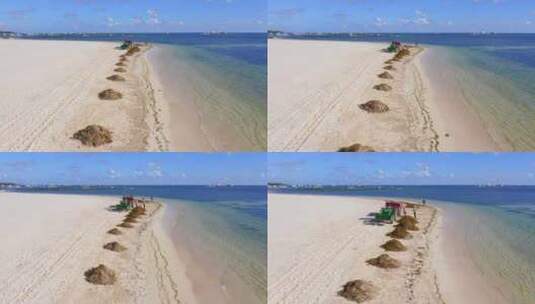 多米尼蓬塔卡纳白沙中，工人和海滩清洁机清除了成堆的海藻高清在线视频素材下载