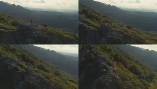 站在岩山顶上看下面绿色山谷的人高清在线视频素材下载