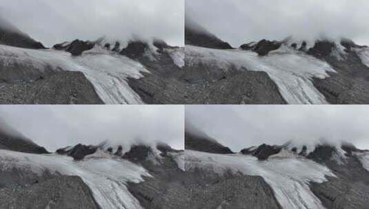 航拍云雾中的四川横断山脉乌库楚雪山风光高清在线视频素材下载