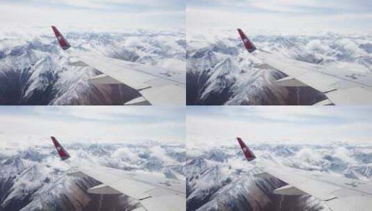 透过飞机舷窗往外看，飞机在雪山和云海上高清在线视频素材下载