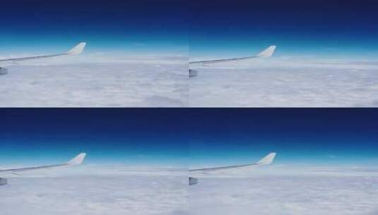 飞机上看窗外机翼划过蓝天白云高清在线视频素材下载