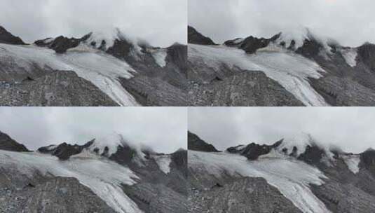 航拍云雾中的四川横断山脉乌库楚雪山风光高清在线视频素材下载