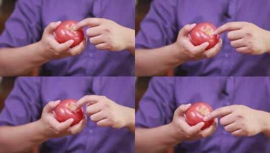 手里拿西红柿高清在线视频素材下载