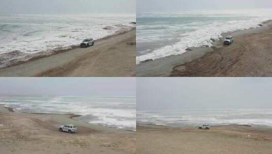 4K航拍汽车孤独的行驶在冰湖边的沙石路上高清在线视频素材下载