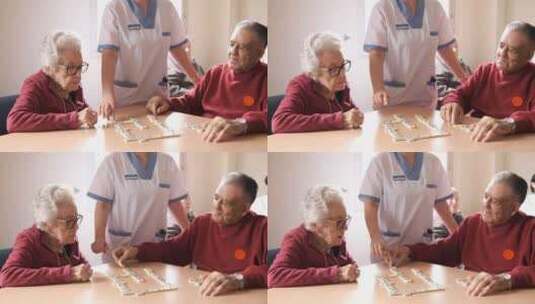 护士在养老院食堂与老年男女玩多米诺骨牌高清在线视频素材下载