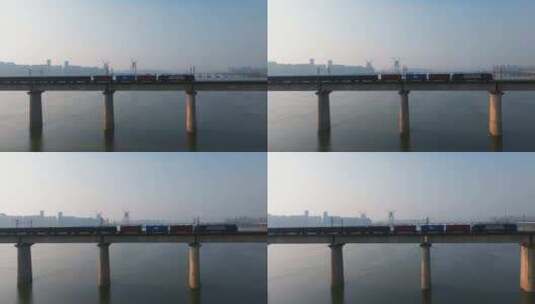 货运火车飞驰过城市跨江大桥高清在线视频素材下载