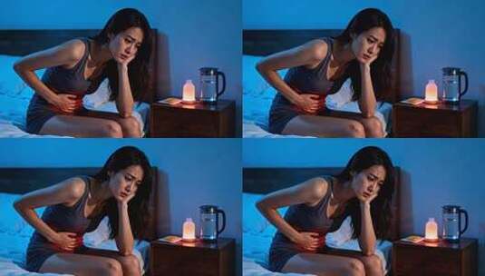 夜晚床上腹痛的年轻女性高清在线视频素材下载