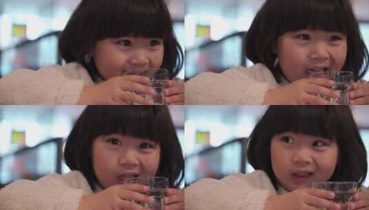 在餐厅喝水的亚洲女孩高清在线视频素材下载