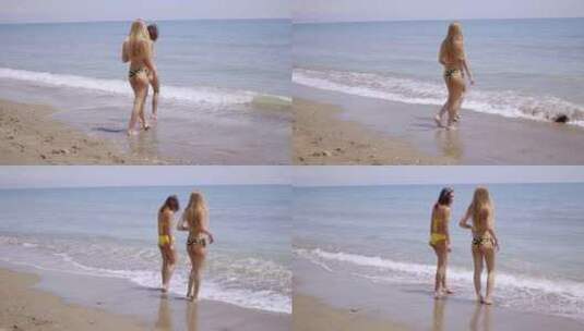 两个穿着泳衣的年轻女人站在海里高清在线视频素材下载