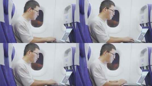 男子在飞机上使用笔记本电脑高清在线视频素材下载
