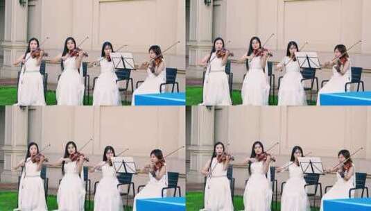 4K升格实拍四名草坪上演奏小提琴的女孩高清在线视频素材下载