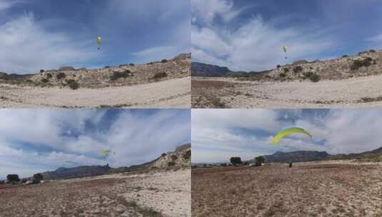 4K滑翔伞运动飞行降落在蓝天白云草地树林间高清在线视频素材下载