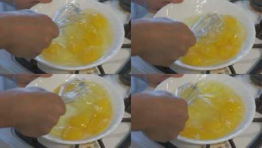 女人用搅拌器慢动作在白色碗里炒鸡蛋高清在线视频素材下载