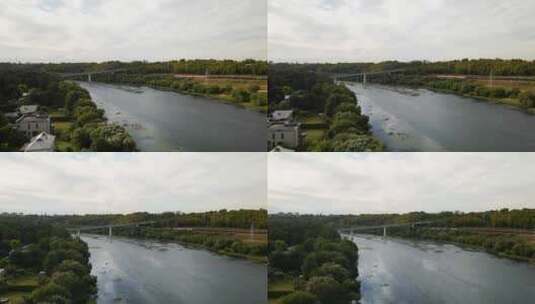 航拍河面的桥梁和旁边的列车高清在线视频素材下载