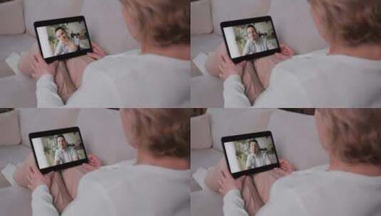 妇女使用平板电脑与儿子视频通话高清在线视频素材下载