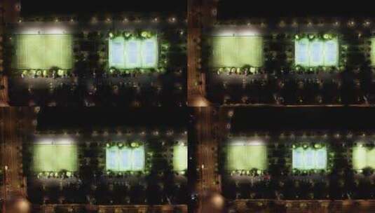 航拍夜间灯火通明的足球场和网球场高清在线视频素材下载