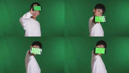 可爱的中国小男孩展示绿屏智能手机高清在线视频素材下载