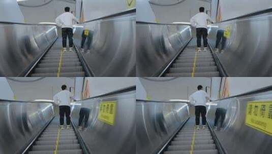 一个人乘坐手扶电梯背影高清在线视频素材下载