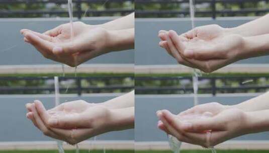 张开双手接水的特写镜头高清在线视频素材下载