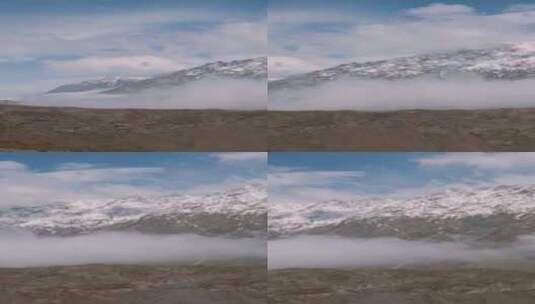 远眺被大雪和云雾覆盖的山脉高清在线视频素材下载