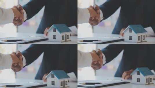 商务人士握手 房产模型置于桌上高清在线视频素材下载