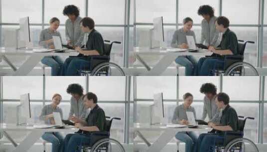 轮椅上的人与同事讨论工作问题成功多元化的高清在线视频素材下载