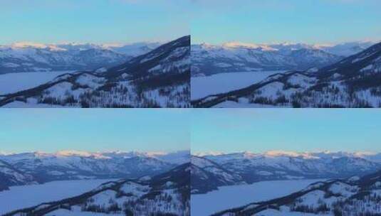 新疆阿勒泰冬季喀纳斯湖雪山水墨画雪景日出高清在线视频素材下载