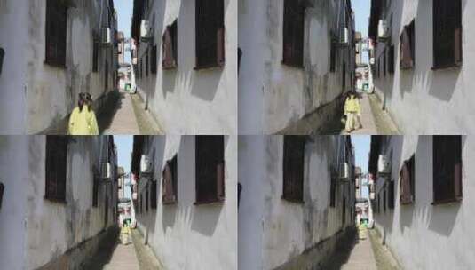 可爱女孩走在江南古镇小巷中背影高清在线视频素材下载