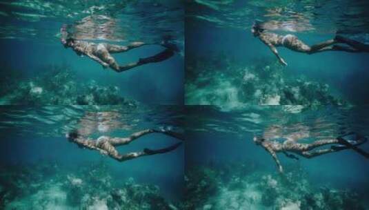 女人在海洋珊瑚礁上浮潜高清在线视频素材下载