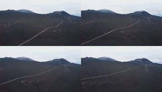 吉普车在火山地带驶向山脉上空高清在线视频素材下载