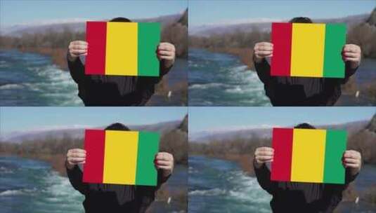 手持几内亚国旗横幅的人高清在线视频素材下载