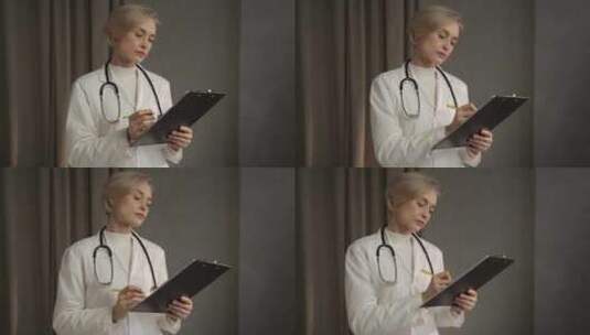 日间在诊所查阅病历的高级女医生高清在线视频素材下载