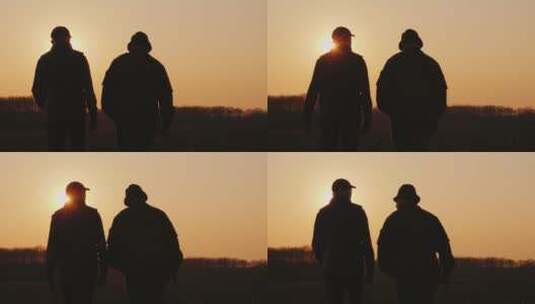 日落时分男人在田野散步高清在线视频素材下载