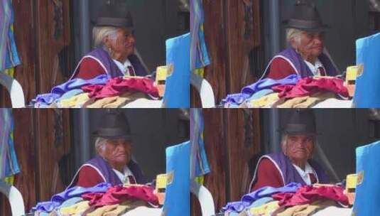 一位老年土著妇女坐一家商店里高清在线视频素材下载