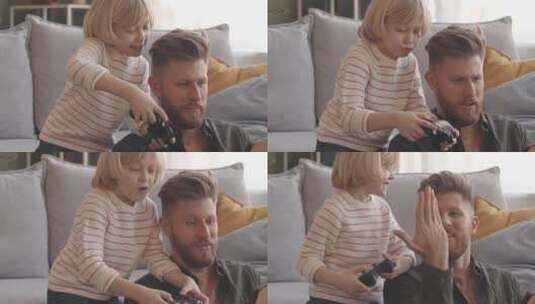 爸爸和小儿子在家玩电子游戏高清在线视频素材下载