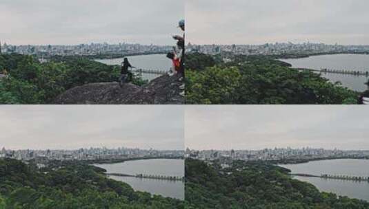 小轮车手在宝石山上俯瞰杭州城市高清在线视频素材下载