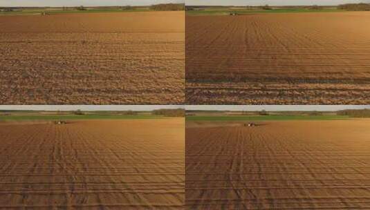 在尘土飞扬的田野鸟瞰图中用拖拉机和播种机播种田地高清在线视频素材下载
