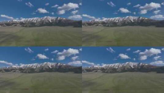 蓝天白云下的赛里木湖边雪山和草地高清在线视频素材下载