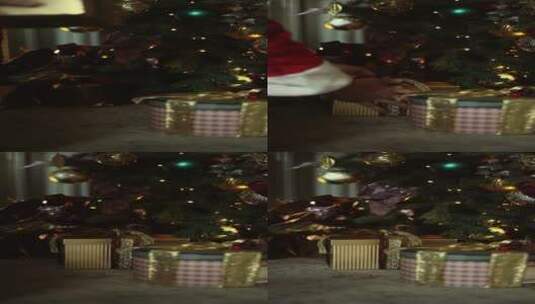 一个人把一盒礼物放在圣诞树下高清在线视频素材下载