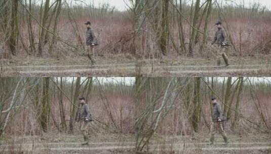 男子手持鱼竿在树林中行走高清在线视频素材下载
