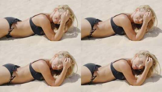 穿着比基尼女子躺在沙滩上高清在线视频素材下载