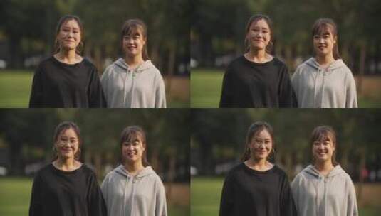 两位中国女大学生在大学校园看镜头微笑高清在线视频素材下载