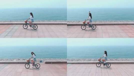 女孩儿海边骑自行车高清在线视频素材下载