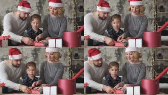 圣诞节父母陪孩子拆礼物高清在线视频素材下载