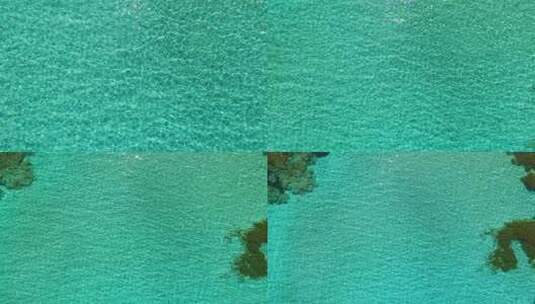 当相机上升放大时，无人机俯瞰绿松石清澈的热带水域高清在线视频素材下载