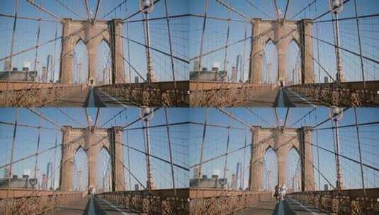 一个夏天，年轻的欧洲浪漫夫妇在布鲁克林大桥手拉手旋转，跑向镜头。高清在线视频素材下载